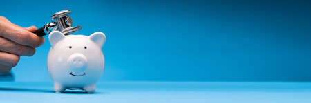 Doctor Health Checking Piggy Bank With Money Insideの写真素材