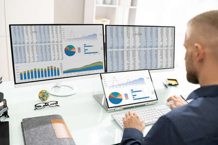 Analyst Working With Spreadsheet Business Data On Computer