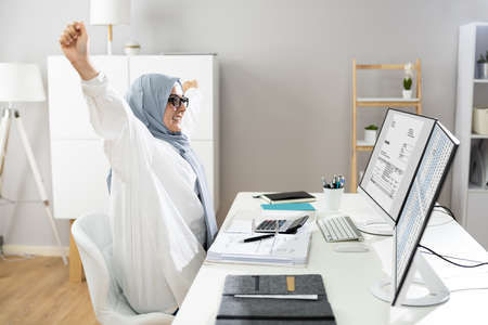 Stretch Exercise At Office Desk Near Computerの写真素材