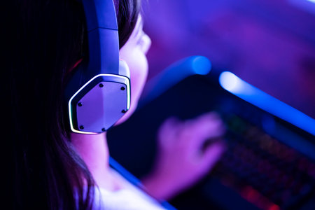 Online Esports PC Player In Headphones. Young Gamer Girl