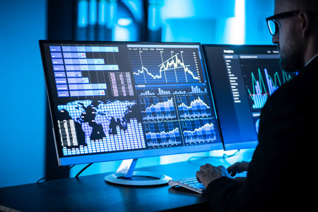 Business Analyst Working Late Using KPI Dashboardの写真素材