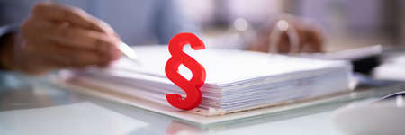 Red Paragraph And Calculator At Judicial Attorney Deskの写真素材