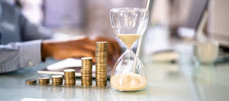 Increasing Money Coin Stack Concept. Hourglass And Time
