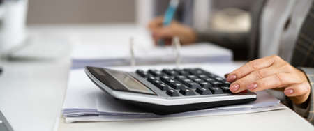 Accountant Calculating Financial Budget And Invoice In Office