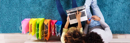 African Family Couple Shopping Online On Laptopの写真素材