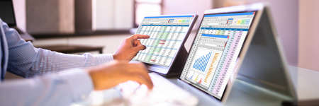 African American Analyst Using Spreadsheet On Screen