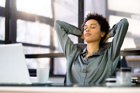 African American Woman Indoor In Office Behind Laptop