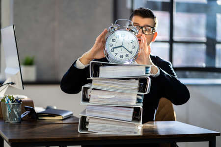 Man Working With Paperwork. Business Deadline Alarmの写真素材
