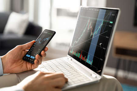 Stock Broker Trading Stocks Online On Laptop