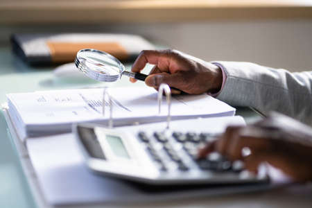 Auditor Using Magnifying Glass For Audit And Fraud Investigationの写真素材