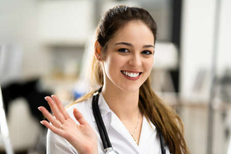 Doctor Waving In Online Video Call Meetingの写真素材