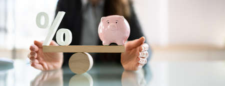 Balance Scale Interest Percentage And Pension Money Budgetの写真素材