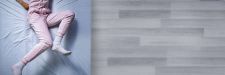 African American Woman With RLS - Restless Legs Syndrome. Sleeping In Bed