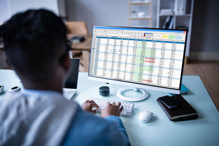 Man Using Finance Spreadsheet Report On Laptop Screen