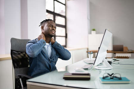Bad Posture Neck Pain At Office Computerの写真素材