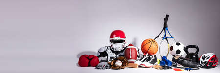 Variety Of Sport Balls And Equipment In Front Of Gray Surfaceの写真素材