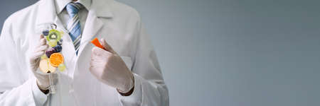 Male Doctor Holding Saline Bag With Fruit Slices Inside In Hospital