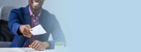 Close-up Photo Of Person's Hand Giving Cheque
