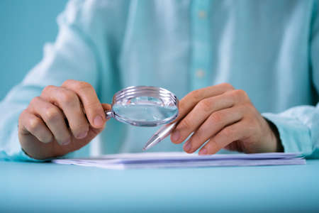 Auditor Using Magnifying Glass For Audit And Fraud Investigationの写真素材