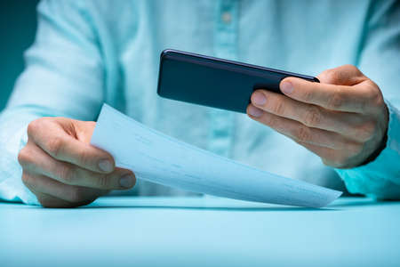 Remote Check Deposit Taking Photo With Mobile Phoneの写真素材