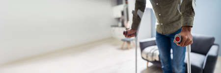 Disabled Man Using Crutches For Walking On Floorの写真素材