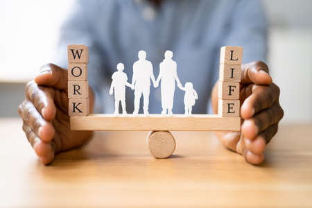 Protecting Balance Between Work And Life With Family Paper Cut Out On Seesawの写真素材