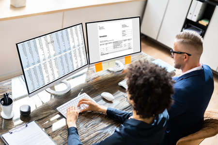Analyst Working With Spreadsheet On Computer Screen