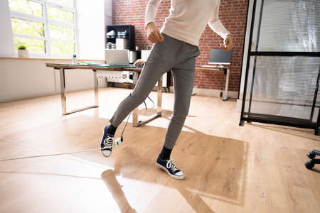 Stumble And Fall Over Wire In Officeの写真素材