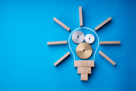 Lightbulb Invention Strategy. Gear Wheel Collaboration And Abstract Lampの写真素材