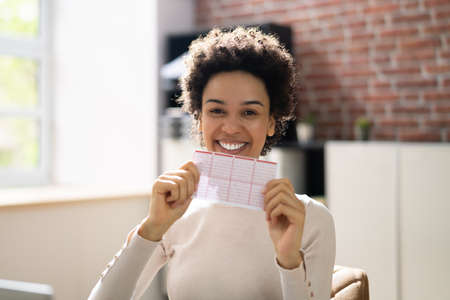 African Lottery Winner Person With Lotto Ticketの写真素材