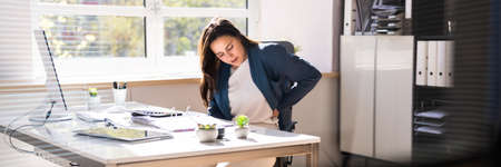 Bad Posture Sitting In Office With Backache In Chair