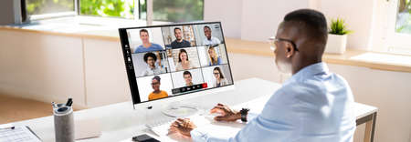 Close-up Of Businessman Looking At Video Conference On Computer