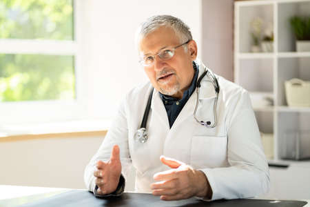 Portrait Of Happy Mature Doctor In Clinicの写真素材