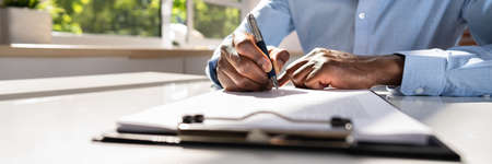 Businessman Signing A Contract In The Office