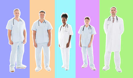 Full length portrait of confident multiethnic medical team standing in row against white backgroundの写真素材