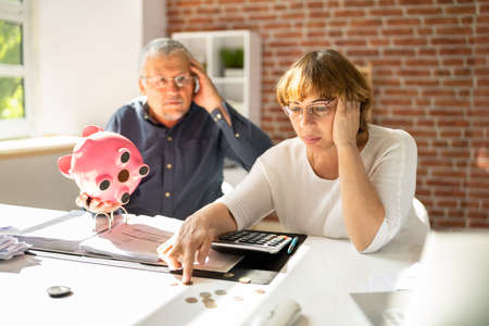 Portrait Of A Couple Sitting On Couch Enjoying Successの写真素材