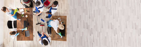Overhead View Of Diverse Janitors In Uniform Cleaning The Office With Cleaning Equipmentの写真素材