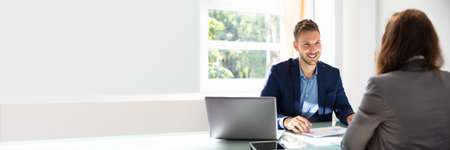 Happy Young Businessman Looking At Candidate During Job Interview