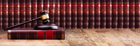 Judge Gavel And Soundboard On Law Book Over The Wooden Desk