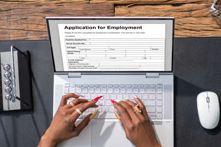 Businesswoman Searching Online Job On Computer In Officeの写真素材