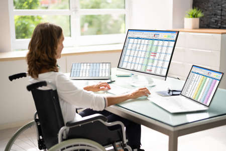 Medical Coding Spreadsheet On PC. Woman In Wheelchair
