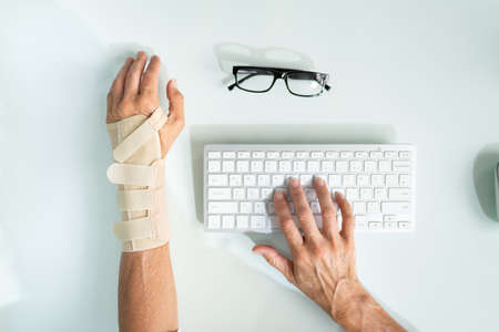 Broken Arm Office Accident. Worker Compensation And Social Coverageの写真素材