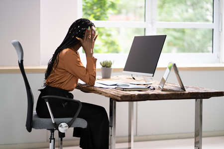 African Business Woman Tired And Upset With Head Acheの写真素材