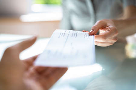 Executive Hand Giving Payment Check Or Compensation Cheque