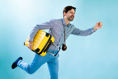 Tourist Man Running With Suitcase To Flightの写真素材
