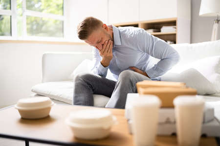 Unhealthy Fastfood Stomach Heartburn. Person After Eating Foodの写真素材