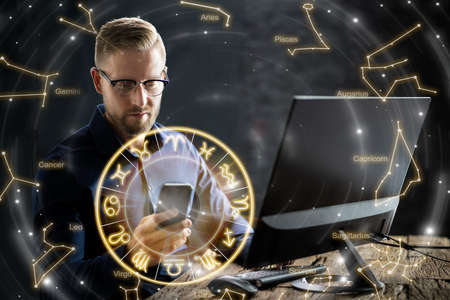 Man Watching Horoscope On Smartphone At Night. Astrology Conceptの写真素材