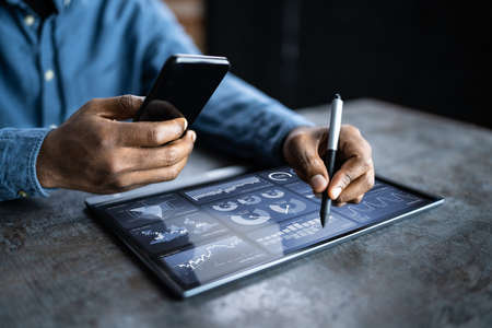 Financial Analyst Using Analytics Technology On Tablet