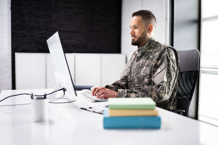 Military Student Education. Army Soldier Veteran With Computerの写真素材