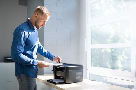 Midsection Side View Of Businessman Pressing Printer's Button In Officeの写真素材